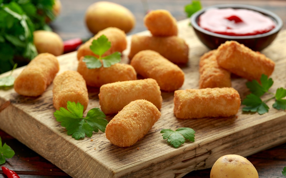 Croquetas de papa en una tabla.