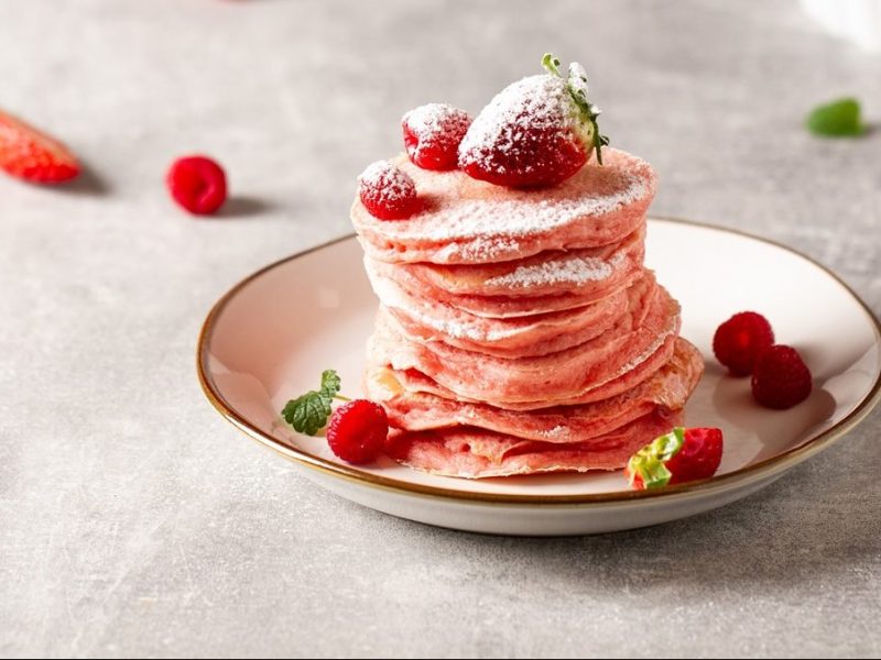 Plato con una pila de panqueques rosas